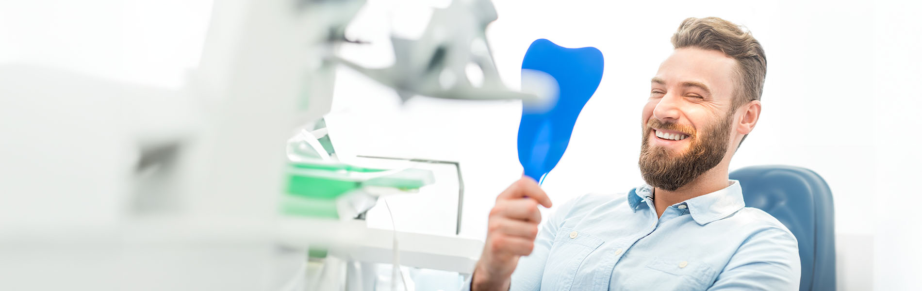 The image is a photograph of a woman with light skin, smiling at the camera. She appears to be in her late twenties or early thirties and has long hair. Her eyes are looking directly at the camera, and she is holding up her index finger near her mouth as if she's making a point or emphasizing something. The background is plain and light-colored, which suggests that this could be a stock photo used for various purposes such as advertising, personal branding, or lifestyle content.